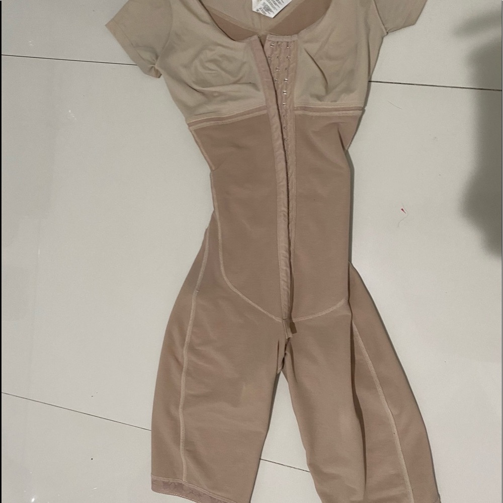 Body suit for compressing after surgery